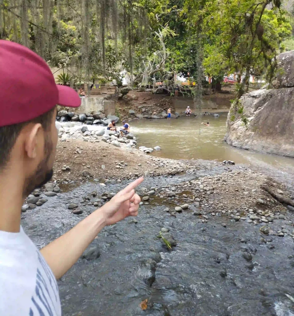 Andres at the river pointing the way